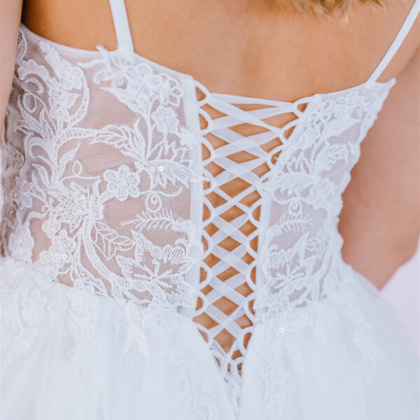 Delicate floral lace creates a translucent bodice