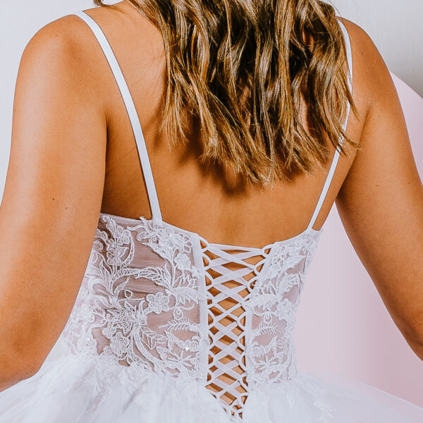 Delicate floral lace creates a translucent bodice